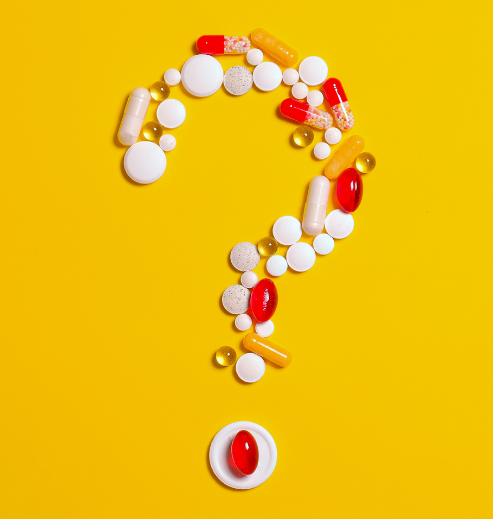 Question mark made of pills symbolizing key questions about Periodic Safety Update Reports (PSUR) and their role in pharmacovigilance.