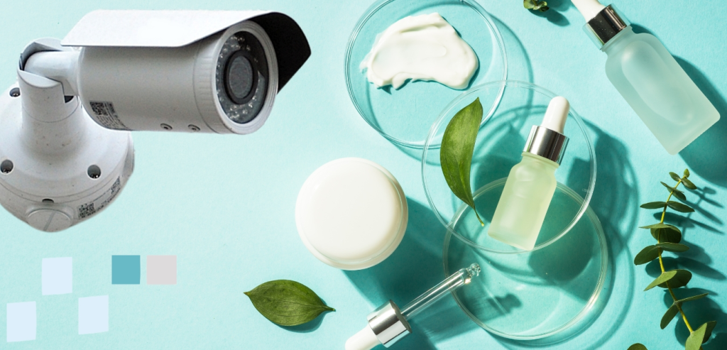 A security camera in the foreground, bottles of serum, cosmetic jars, creams and laboratory equipment in the background